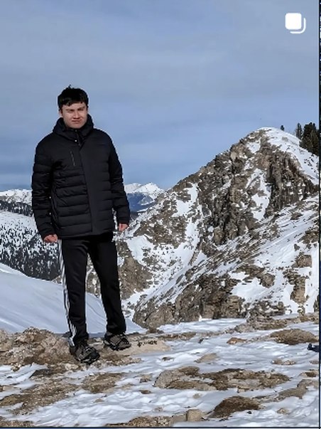 Standing on a snowy summit