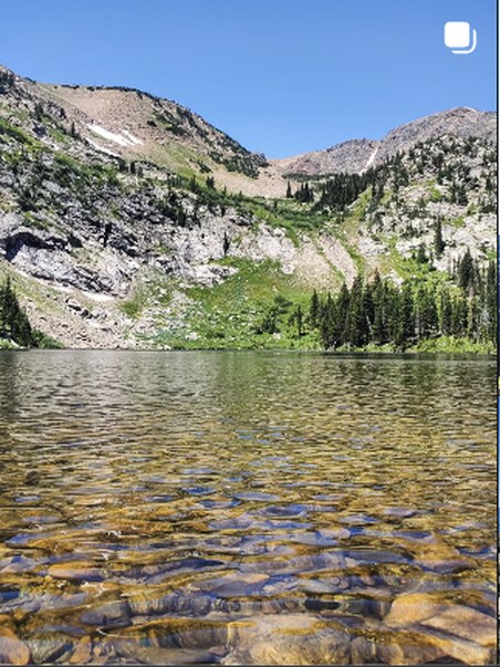 Wide view of a clear alpine lake