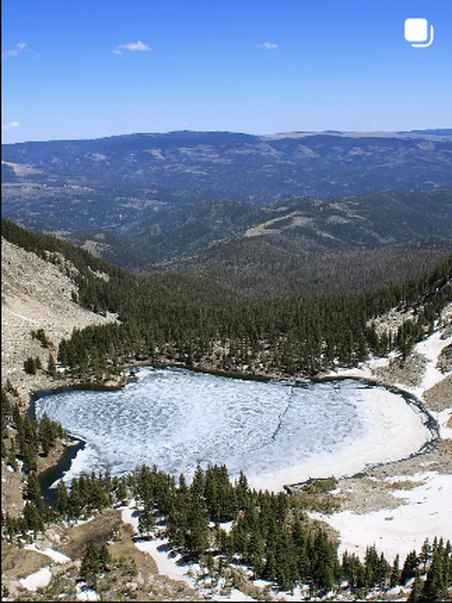 Aerial view of a frozen alpine lake
