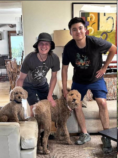 On the couch with two poodles and a friend