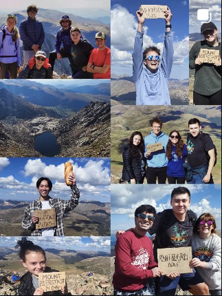 Hiking group at a summit sign