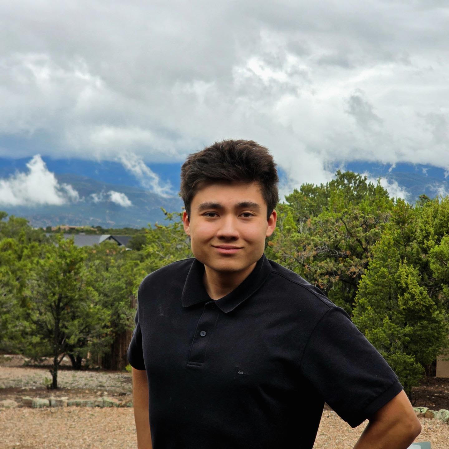 Griffin Rutherford outdoors with mountains in the background